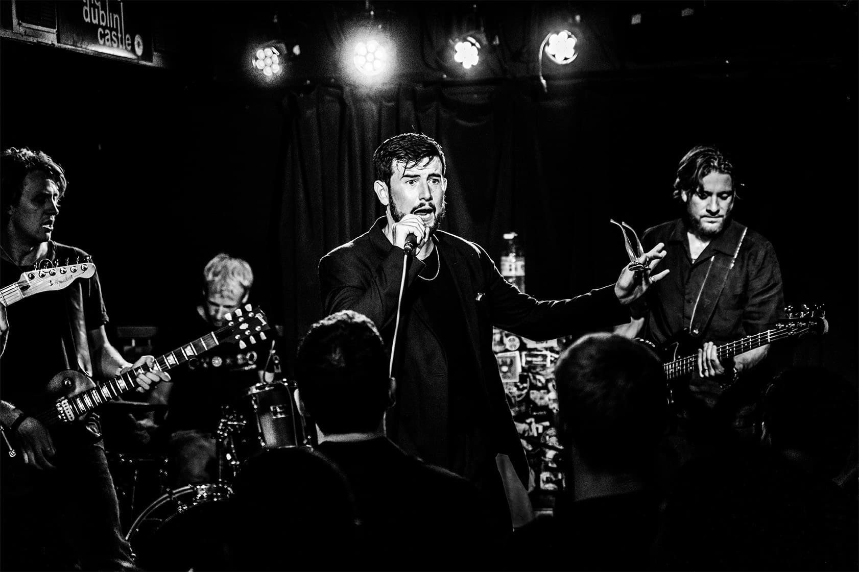 The band on stage in black and white