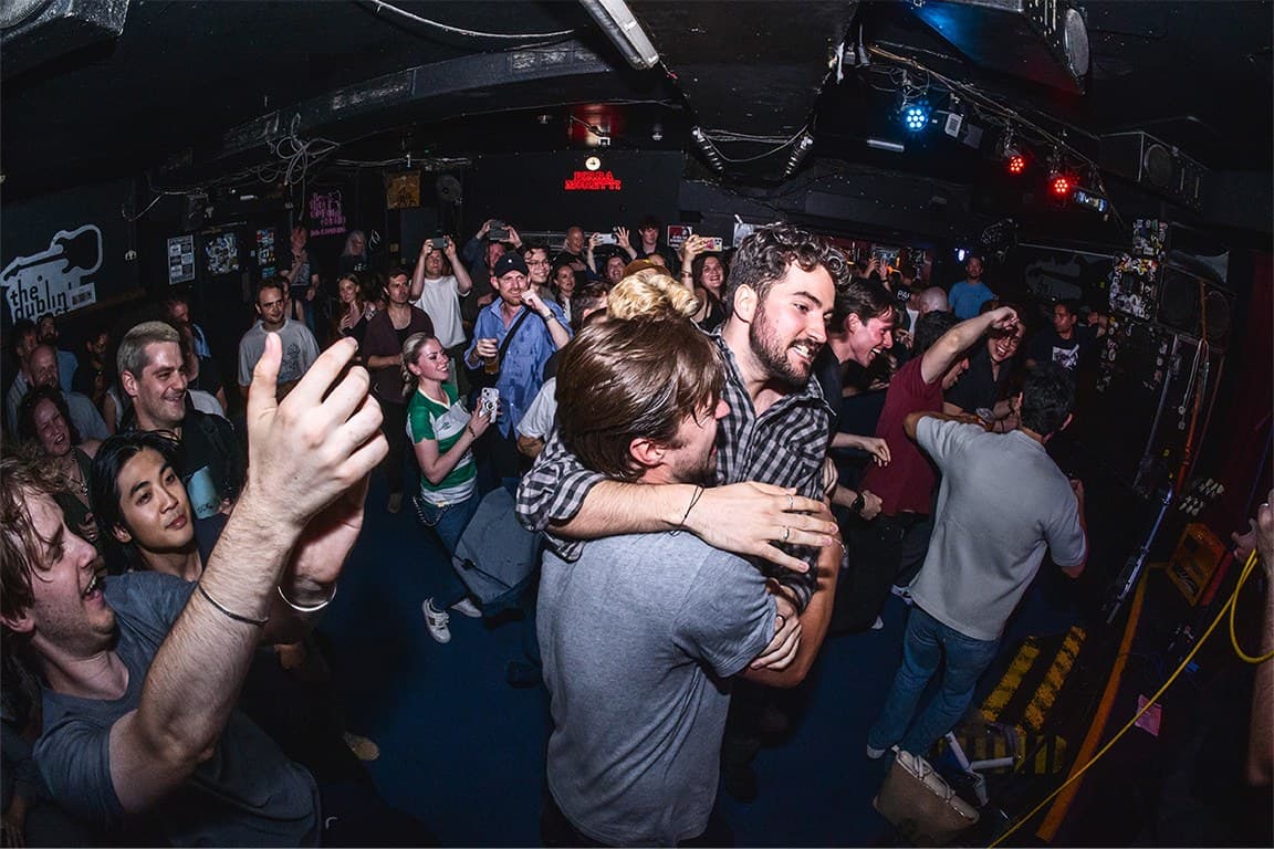Fans embracing in the crowd