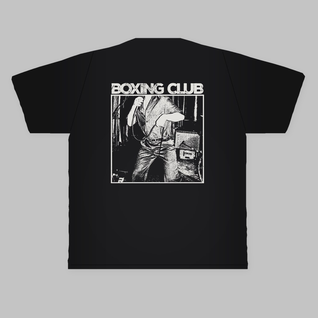 Back of a black Boxing Club T-shirt with a white print of the band's name over a live photo